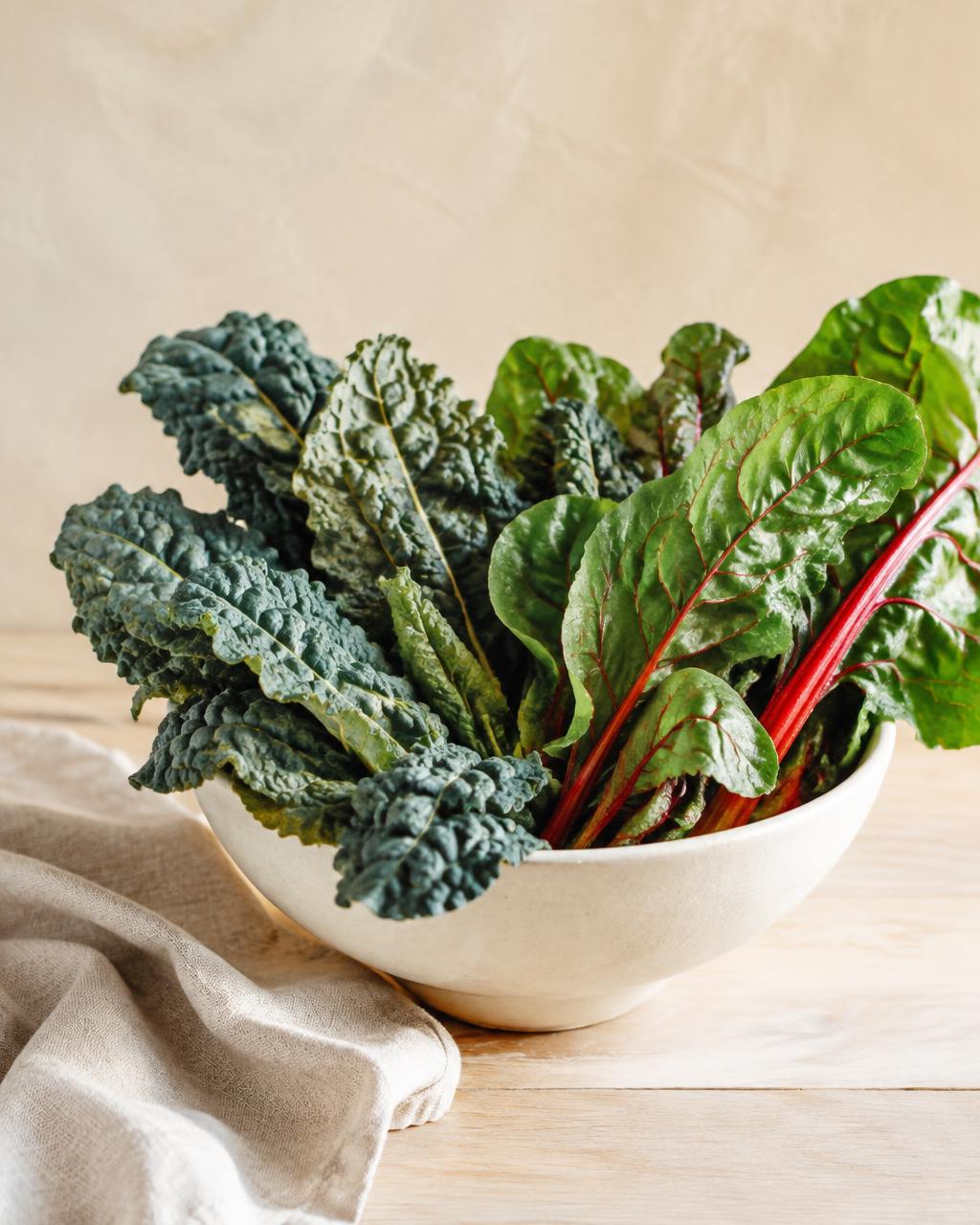 Tuscan kale and chard in a cream ceramic bowl